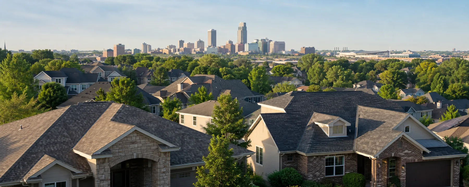 Residential rooftops with the Omaha skyline in the distance